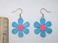 This is a Uniquely Handcrafted pair of Earrings featuring Super Cute & Colorful BLUE FLOWERS Featuring a decorative PINK center - Completely Handmade Artisan Earrings displaying OUTRAGEOUS Details= Earwires are Hypoallergenic. Super FUN- Beautiful Colors Dangle nicely from ears, Light weight. - Length = Please See pictures for ruler measurement & DETAILS :) Please SEE my other listings for MORE fun HOLIDAY THEMED Polymer Clay Earrings Thank You for Looking Please Check out my other items Retro Flower Earrings For Gift, Retro Adjustable Pink Earrings, Retro Flower Shaped Earrings As Gift, Retro Flower Shaped Earrings For Gift, Retro Flower Shape Earrings For Gift, Retro Handmade Flower Jewelry, Retro Multicolor Flower Jewelry, Handmade Retro Flower Earrings, Retro Flower-shaped Earrings For Gift