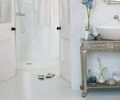 a bathroom with a sink, mirror and shower