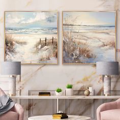 two paintings hang on the wall above a coffee table in a living room with pink chairs