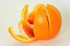 an orange cut in half on a white surface