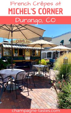 an outdoor dining area with tables and umbrellas in front of the restaurant, which is located at michel's corner durango, co