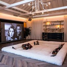 a living room filled with furniture and a flat screen tv mounted to the wall above it