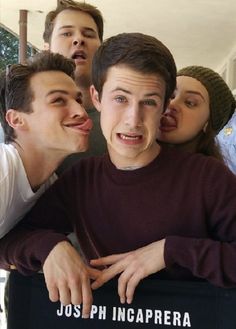 a group of young men standing next to each other in front of a mirror with their mouths open