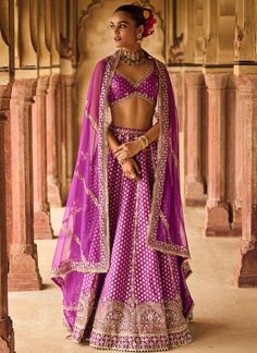 a woman in a purple lehenga and blouse