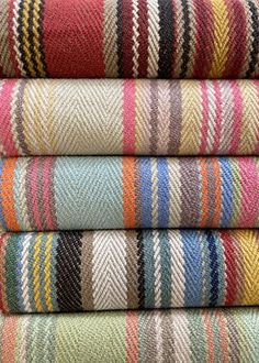 multicolored striped fabric stacked on top of each other in different sizes and colors