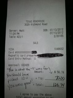 a receipt from the texas roadhouse, which has been placed in front of a computer monitor