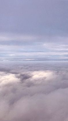 an airplane flying above the clouds on a cloudy day