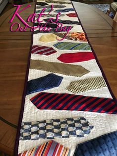 a quilted table runner with ties on it and the words kaffe's out of the bay