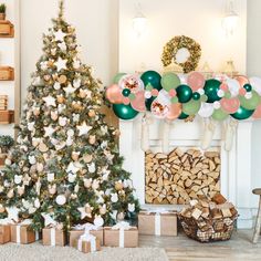 a decorated christmas tree in front of a fireplace with balloons and presents on the mantle