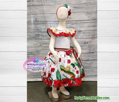 Perfect dress to celebrate Mexican heritage Cinco de Mayo, Mexican Independence Day or a Fiesta Theme Party! Ruffled white dress with Mexican symbols maracas, guitars, sombreros, Mexican flag eagle, cactuses, red roses printed all over the dress. Includes rebozo (shown around waist) Complete the outfit by adding our matching flower headpiece. We ship FAST! More designs available, if you have any questions, please don't hesitate to send me a message! @partypiecesmcallen.com Traditional White Dress With Ruffles, White Dresses For Cinco De Mayo Fiesta, Mexican Flag Eagle, Mexican Symbols, Mayo Dress, Mexican Fiesta Dresses, Mexican Independence Day, Mexican Independence, Fiesta Dress