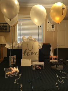 some balloons and pictures on a table