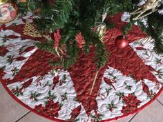 a christmas tree skirt with ornaments on it