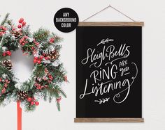 a christmas wreath next to a blackboard with the words sleigh balls are ring on your listening