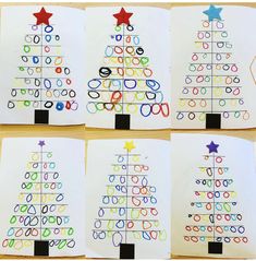 four christmas tree cards with colored circles and stars on them, all lined up in different colors