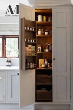 an open cabinet in the middle of a kitchen