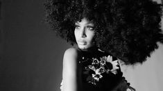 a black and white photo of a woman with an afro