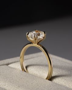 a gold ring with two diamonds on it