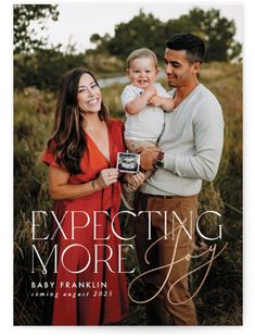 the expecting more photo card features an image of a man and woman holding a baby