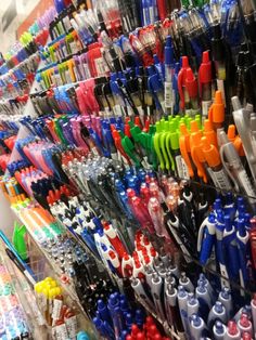 there are many different colored toothbrushes on display