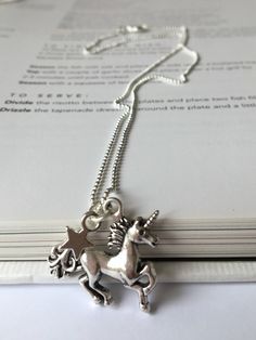 This magical necklace features a stunning silver unicorn (27 x 22mm) and a delicate star charm strung on a sterling silver ball chain (18 inches). A range of matching bracelets is available. Each necklace comes attached to a presentation card and with an organza dust bag. Thanks for looking! Adjustable Silver Charm Necklaces With Star Charm, Adjustable Sterling Silver Charm Necklaces With Star Charm, Adjustable Sterling Silver Star Charm Necklace, Adjustable Sterling Silver Necklace With Star Charm, Magical Silver Charm Necklaces As Gift, Magical Silver Charm Necklaces For Gift, Birthday Silver Charm Necklace, Silver Star Charm Jewelry For Birthday, Silver Jewelry With Star Charm For Birthday