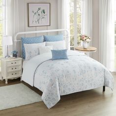 a bed with blue and white comforters in a bedroom