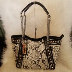 Handbag Express Snake Skin Rhinestone And Studded Tote Mesmerizing Stones And Studs, Patent Trim That Shines Across A Tote. That Is Finished With A Chain Handles Is What You Wear When You Want To Be Noticed Has Back Zipper Pocket 10 Inch Drop Length Straps Made Of Faux Leather And Fully Lined Interior Includes Two Slip Pockets And One Zippered Pocket Top Zipper Closure Silver Hardware Brand New Luxury Bags With Rhinestone Fringe, Glamorous Leather Embellished Bags, Glamorous Embellished Leather Bags, Elegant Leather Shoulder Bag With Rhinestones, Luxury Rhinestone Shoulder Bag For Everyday Use, Luxury Rhinestone Bags For Shopping, Rectangular Shoulder Bag With Silver Accents, Luxury Silver Shoulder Bag With Rhinestones, Glamorous Silver Shoulder Bag With Rhinestones