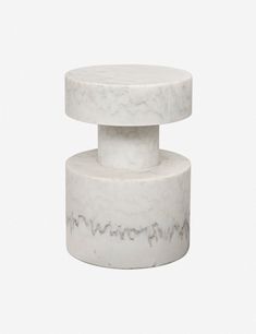 two white marble pedestals stacked on top of each other