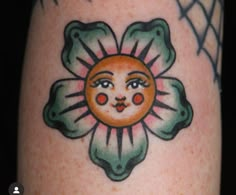 a close up of a person's leg with a flower tattoo design on it