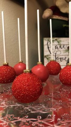 some red christmas ornaments are on a table