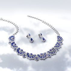 Crafted in 45.74 grams of 14K White Gold, the jewelry set contains 846 Stones of Round Natural Diamonds with a total of 3.78 carat in G-H Color and VS Clarity combined with 75 Stones of Pear/Round Shaped Simulant Blue Sapphire with a total of 37.36 carat. The Necklace is 16-inch in Length. Fine Jewelry Sets In White Gold For Formal Occasions, Formal White Gold Fine Jewelry Sets, Luxury Hallmarked Jewelry Sets For Formal Occasions, Luxury Diamond Cut Jewelry Sets For Formal Occasions, Luxury Formal Jewelry Sets With Diamond Cut, Luxury Gemstone Jewelry Sets For Formal Occasions, Hallmarked Fine Jewelry Sets For Formal Occasions, Fine Jewelry Sapphire With Matching Earrings, Formal White Gold Jewelry Sets With Gemstones