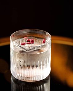 a glass filled with liquid sitting on top of a table