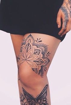 a woman with tattoos on her legs and thigh