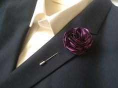 a lapel flower is placed on the lapel of a man's jacket