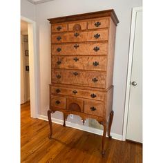 an old wooden dresser sitting on top of a hard wood floor