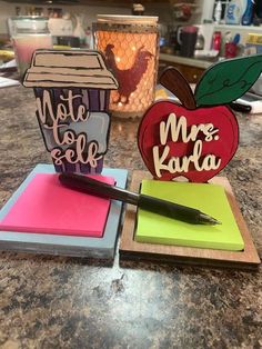 two notebooks and an apple on top of a counter