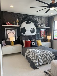 a bedroom decorated in black and white with a soccer theme