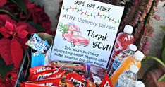 a basket filled with lots of different types of food and drinks next to a sign that says thank you