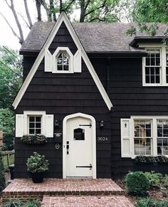 a black house with white trim and windows