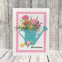 a card with flowers in a watering can