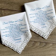 two wedding handkerchiefs with the words dear mom and dad printed on them, sitting on a wooden surface