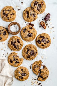 chocolate chip cookies with pecans and sea salt on the side next to a napkin