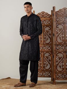 Vastramay Men's Black Mirror Georgette Kurta With Patiala Set Make a statement in this elegant black kurta with a stylish mirror work design. The georgette fabric adds a touch of luxury, perfect for festive occasions or special events. Features: Black georgette kurta with mirror work Patiala set for a complete traditional look Comfortable and stylish Specifications: Brand: VASTRAMAY Color: Black Fabric: Georgette Neck: Mandarin Collar Sleeve Length: Full Sleeves Material & Care: Georgette, Dry-c Transitional Bandhgala With Mirror Work For Party, Transitional Party Bandhgala With Mirror Work, Semi-formal Resham Embroidery Kurta For Diwali, Black Straight Kurta For Party, Diwali Semi-formal Kurta With Resham Embroidery, Bollywood Style Formal Kurta With Mirror Work, Black Dabka Kurta For Party, Formal Unstitched Kurta With Mirror Work, Black Kurta For Party