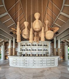 a large room with many lamps hanging from it's ceiling and some drawers below