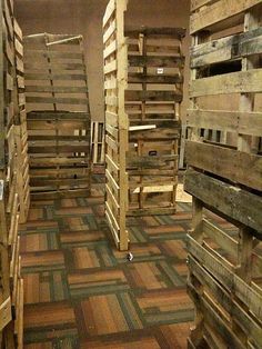 several wooden pallets stacked on top of each other in a room with carpeted flooring