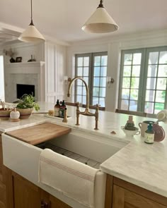 a kitchen with a sink, dishwasher and window in the backround