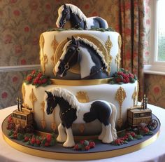 a three tiered cake decorated with horses