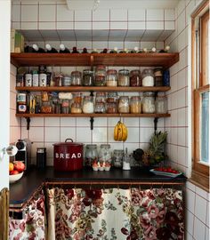 a kitchen with shelves filled with jars and containers