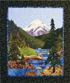 a quilted picture of a mountain lake with trees in the foreground and snow capped mountains in the background