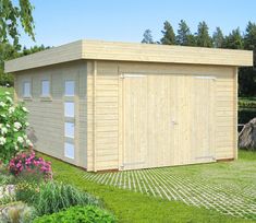 a large wooden shed sitting on top of a lush green field