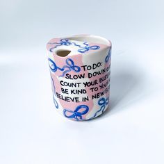 a roll of toilet paper with words written on it and blue bows around the edges